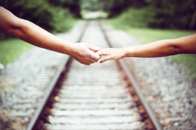 holding hands railroad tracks